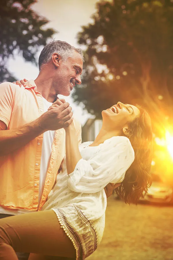 Executive-Wellness-Plans-Treatment A couple dances outside in shades of gold. Get executive wellness plans from Dr. Robert Powers of Eternal Vitality Orlando in Orlando.
