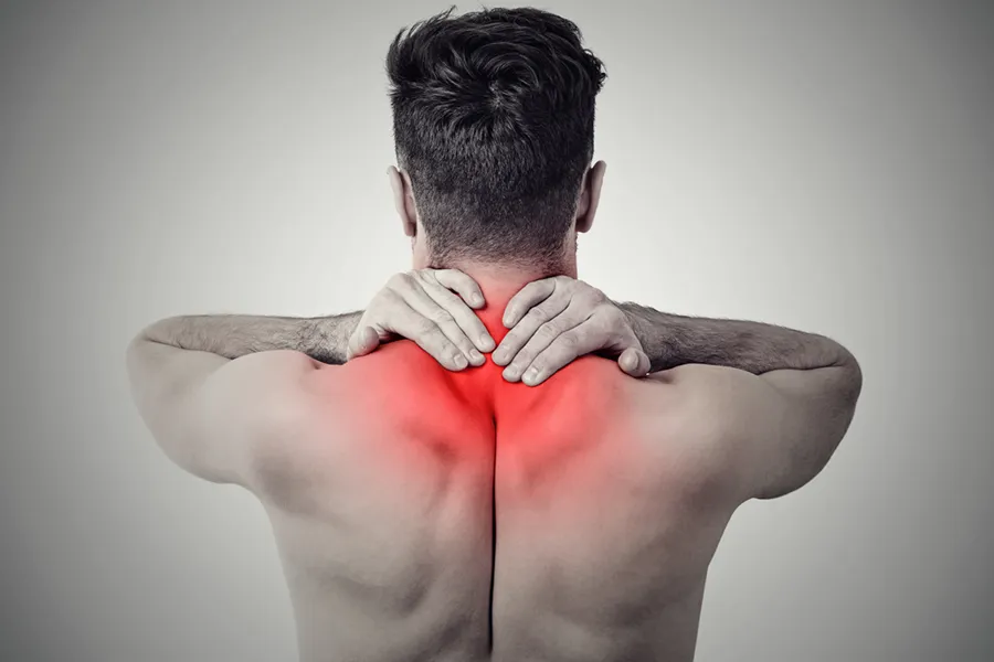 Fibromyalgia-Doctor An image from behind of a man suffering from Fibromyalgia rubbing an area illustrated red with pain in his shoulders and neck . Get fibromyalgia treatment from Dr. Robert Powers of Eternal Vitality Orlando in Orlando.