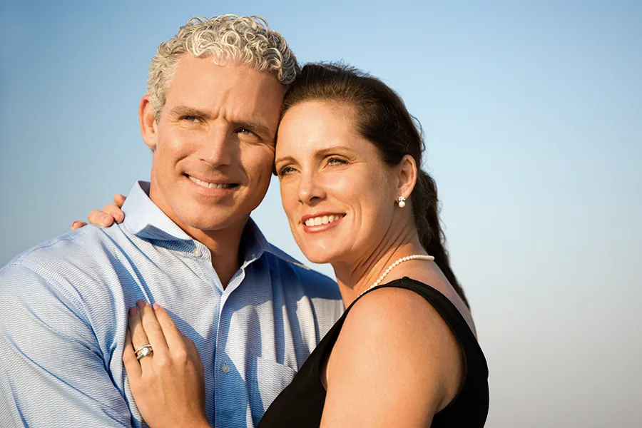Healthy-Aging-Peptides-Doctor A middle-aged caucasian couple embraces in the sunshine, happy with the healthy aging peptide treatments from Dr. Robert Powers of Eternal Vitality Orlando in Orlando