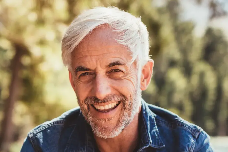 Mens-Health-Clinic A handsome mature man smiling in the forest. Make an appointment with men's health expert Dr. Robert Powers of Eternal Vitality Orlando in Orlando today.