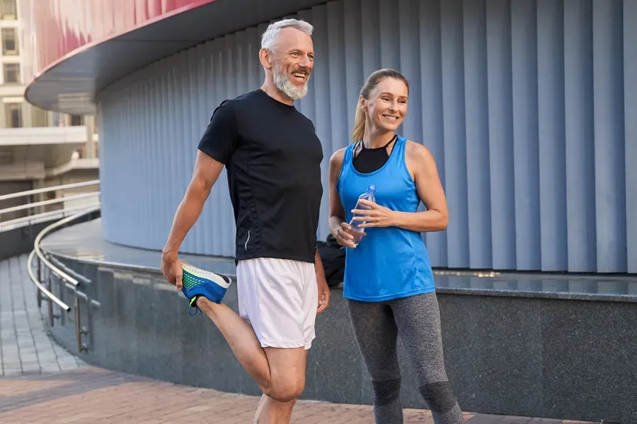 Peptides-for-Healing-and-Recovery-Doctor A middle-aged couple happily stretch and prepare for exercise after receiving effective peptide therapy for healing and recovery from Dr. Robert Powers of Eternal Vitality Orlando in Orlando.