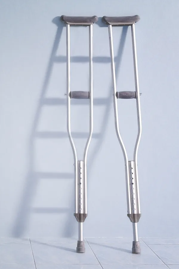 Peptides-for-Healing-and-Recovery-Treatment A pair of crutches rest against a gray wall, representing peptide therapy for healing and recovery from Dr. Robert Powers of Eternal Vitality Orlando in Orlando.